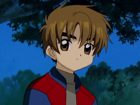 a boy in a red jacket and blue shirt is looking at something