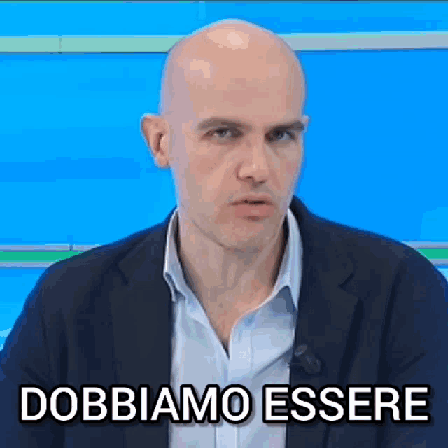 a bald man in a suit says " dobbiamo essere " in a foreign language