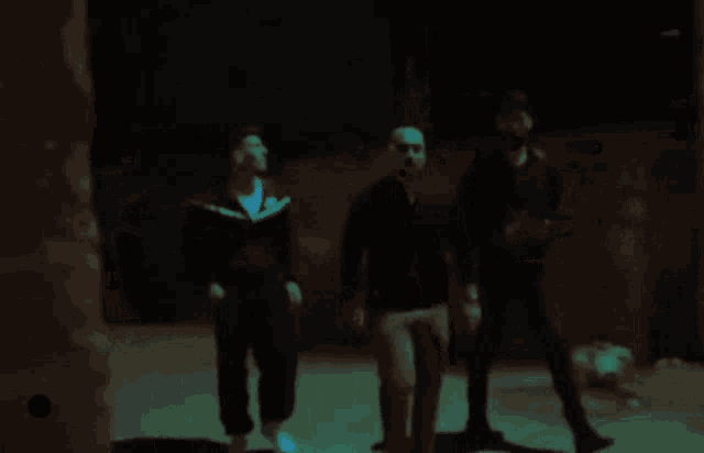 a blurry photo of three men walking down a street