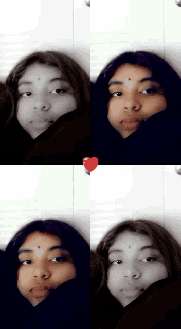 a girl with a red dot on her forehead is taking a selfie