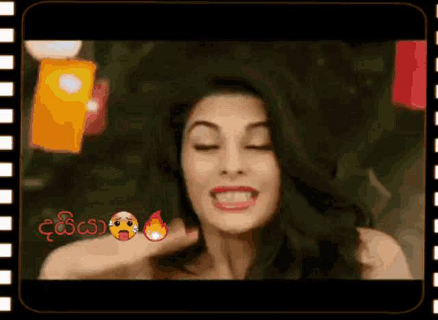a woman is making a funny face with her eyes closed in a film frame .
