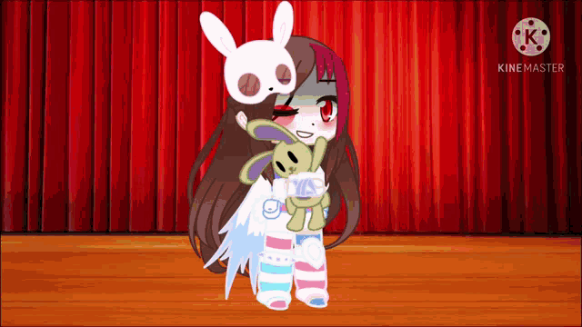 a girl is holding a stuffed animal on a stage .