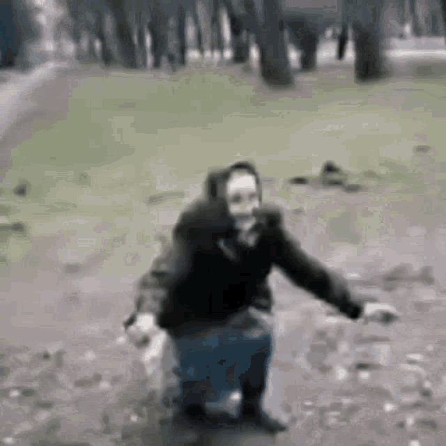 a man is standing in a puddle of water .