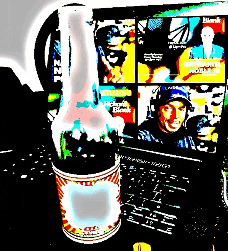 a bottle of ketchup sits in front of a laptop that says blank