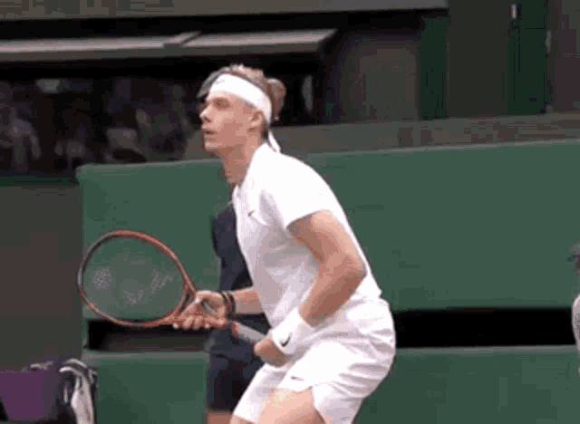 a man holding a tennis racquet on a court
