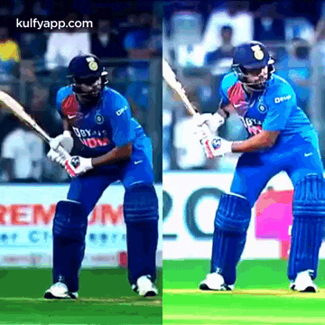 a cricket player is swinging a bat on a field during a game .