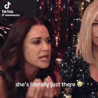 two women are sitting next to each other and one of them is crying while another woman says she 's literally just there .