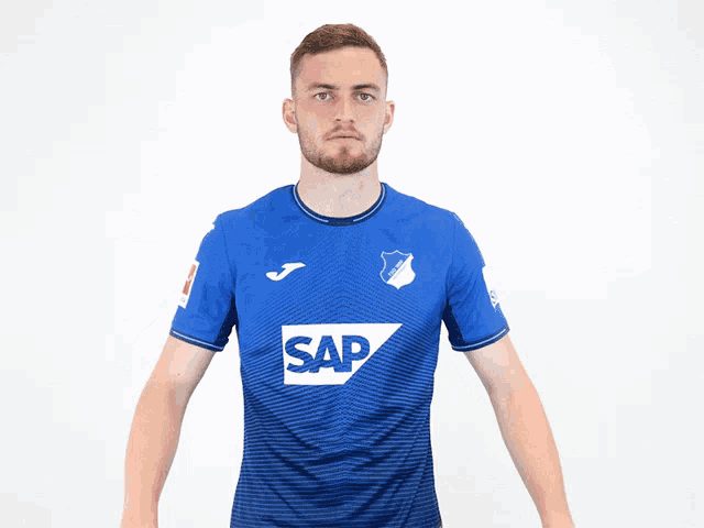 a man is wearing a blue shirt with the word sap on it