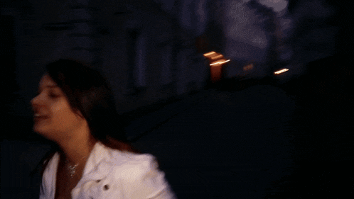 a blurry picture of a woman in a white suit