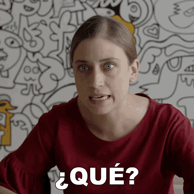 a woman in a red shirt is making a funny face and asking the question que