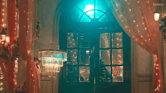 a woman is dancing in a room with a holstar logo on the bottom right