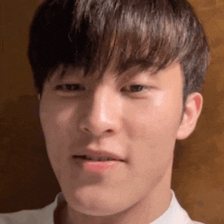 a close up of a young man 's face with a fringe .