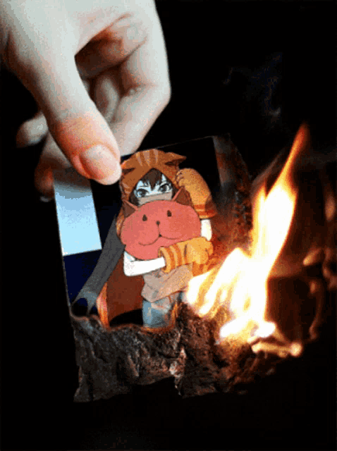 a person is holding a piece of paper with a cartoon character on it