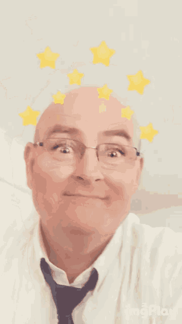 a close up of a man 's face with glasses and stars on his head