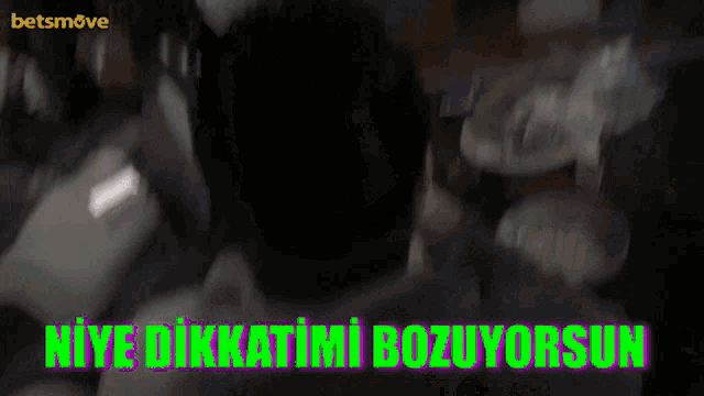 a blurred image of a person with the words " niye dikkatimi bozuyorsun " written in green