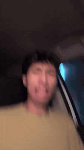 a blurry picture of a man in a yellow shirt