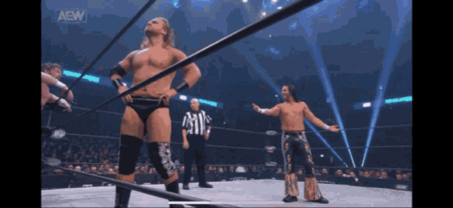 a wrestler in a ring with a aew logo on the bottom