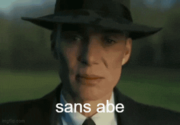 a man wearing a hat is covering his mouth with his hand and the words sans abe are visible behind him