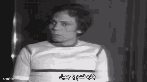 a black and white photo of a man with arabic writing on the bottom