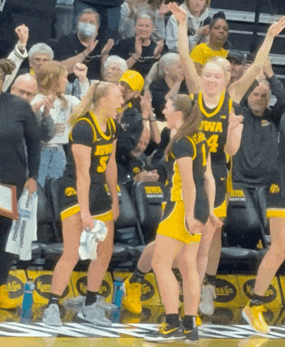 a group of iowa basketball players are celebrating
