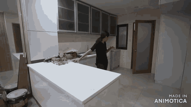 a woman standing in a kitchen with the words made in animatica on the bottom right