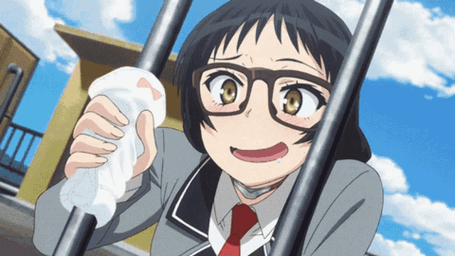 a girl with glasses is holding a white object in her hands
