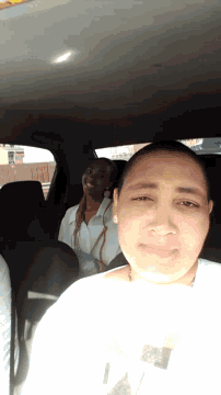 a woman sitting in the back seat of a car