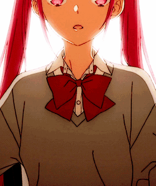 a girl with red hair is wearing a grey sweater and a red bow tie