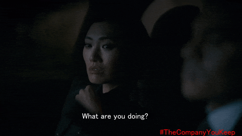 a man and a woman are sitting in a dark room and the man asks the woman what are you doing