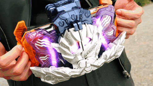 a person is holding a purple and orange toy that says labyrinth