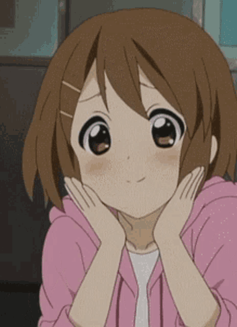 a close up of a girl with her hands on her chin