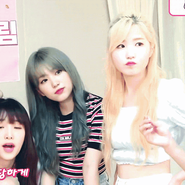 three girls are standing next to each other with one wearing a shirt that says ' g.i. body ' on the front