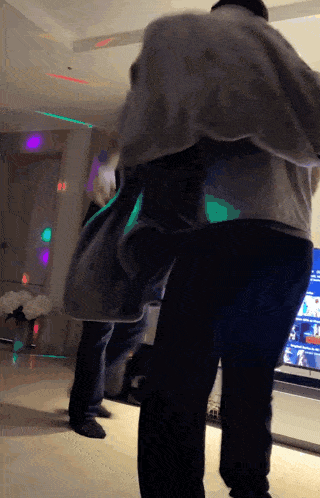 a group of people are dancing in front of a tv