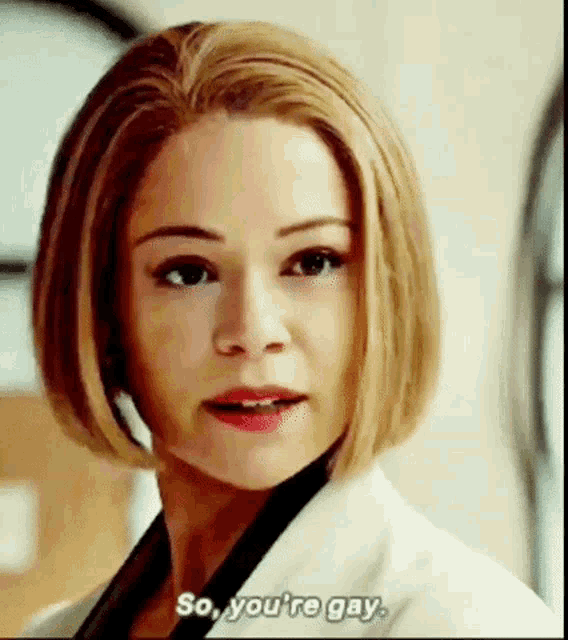 a close up of a woman 's face with the words `` so , you 're gay '' written on the bottom .