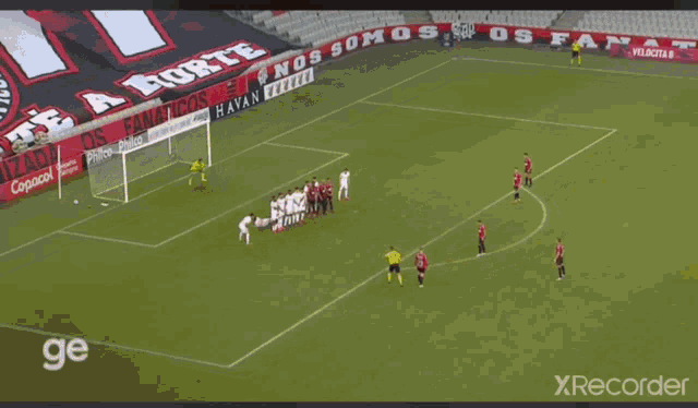two soccer players are hugging each other on the field .