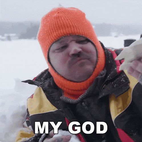 a man wearing an orange hat is holding a piece of snow and says my god