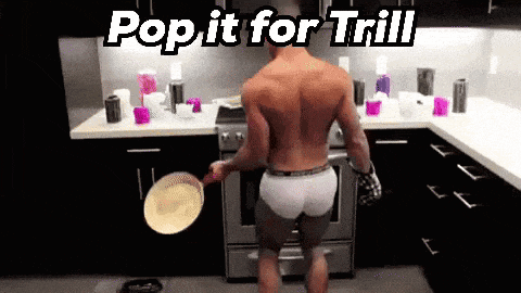 a shirtless man cooking in a kitchen with the words pop it for trill