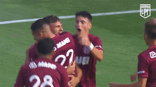 a soccer player wearing a maroon jersey with the number 28 on it