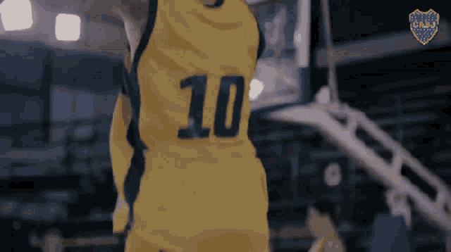 a basketball player is wearing a yellow jersey with the number 10 on the back