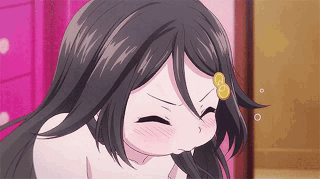 a girl with long black hair has a yellow circle on her forehead ..