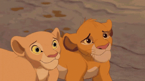 two cubs from the lion king are smiling and looking at the camera