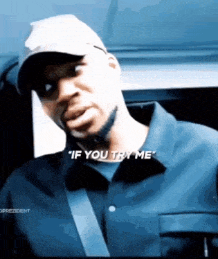 a man in a hat says " if you try me " while wearing a blue shirt