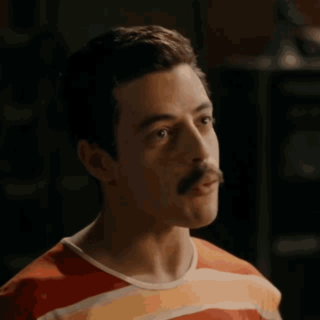 a man with a mustache wearing a striped shirt