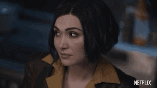 a close up of a woman 's face with the word netflix on the bottom right
