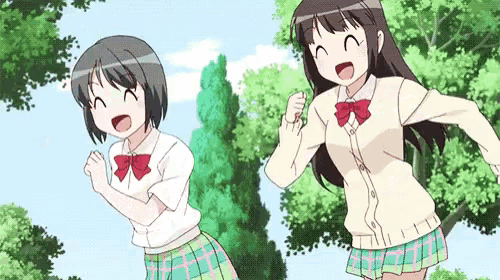 two anime girls in school uniforms are standing next to each other in a park .