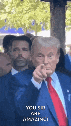 donald trump is pointing at the camera and saying `` you sir are amazing ! ''