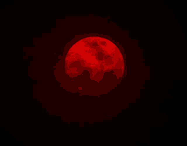a red full moon in a black sky
