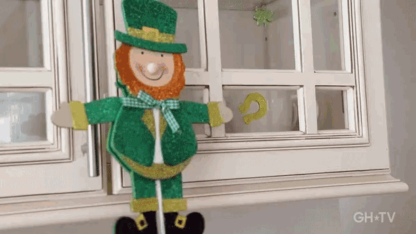 a leprechaun decoration is hanging on a cabinet door with ghtv written on the bottom