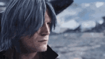 a man with long blue hair and a beard is standing in the desert .