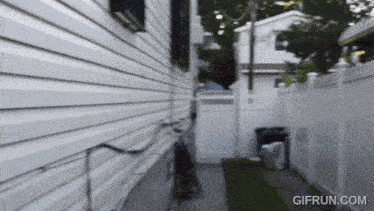 a gif from gifrun.com shows a fenced in yard